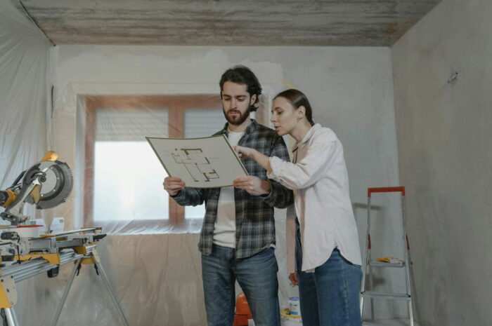 couple looking at home improvement floorplan